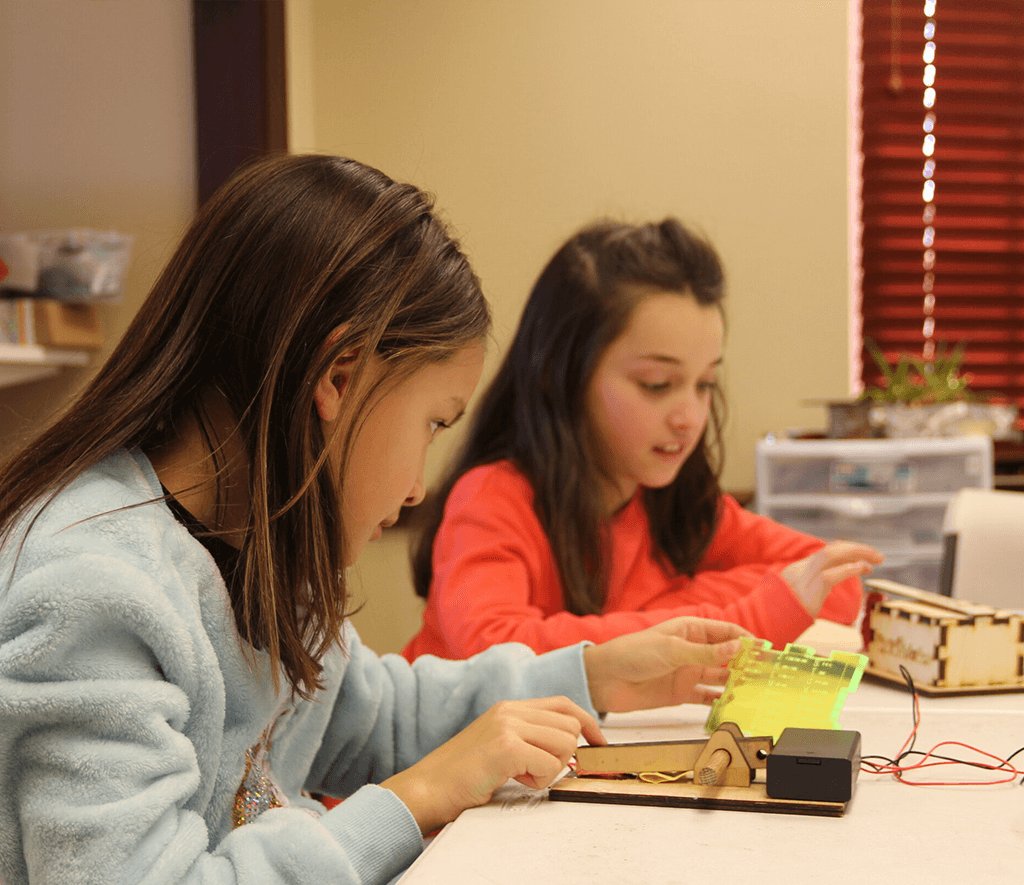 Two girls working on morse code project
