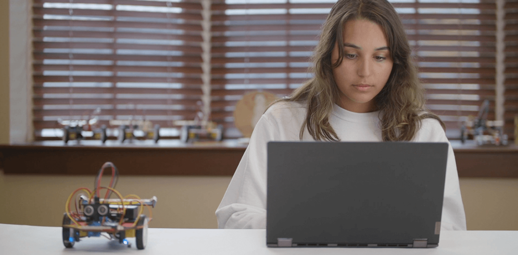 Teen girl working on laptop