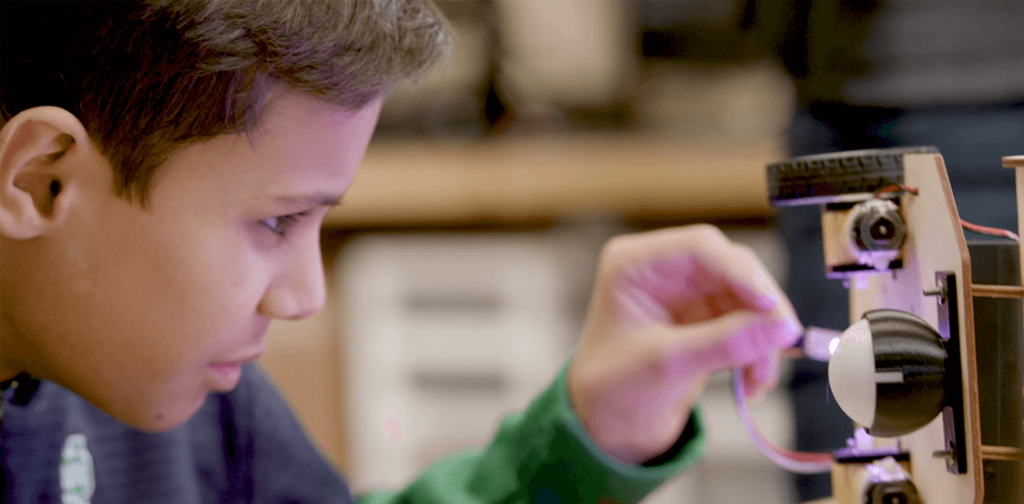 Student assembling a robot